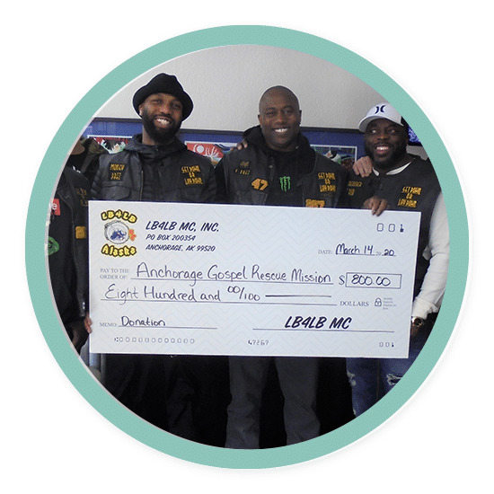 Men showing a large donation check